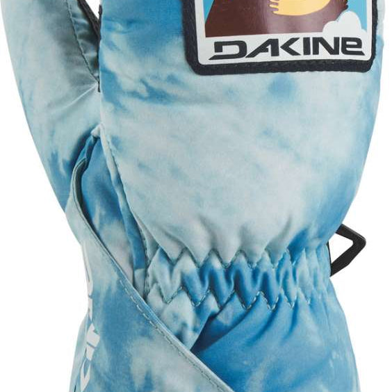 Dakine Toddler Brat Mitt 2022-2023 - A pair of light blue mittens with a white snowflake pattern and black trim, featuring a graphic of a smiling cartoon bear on the back.
