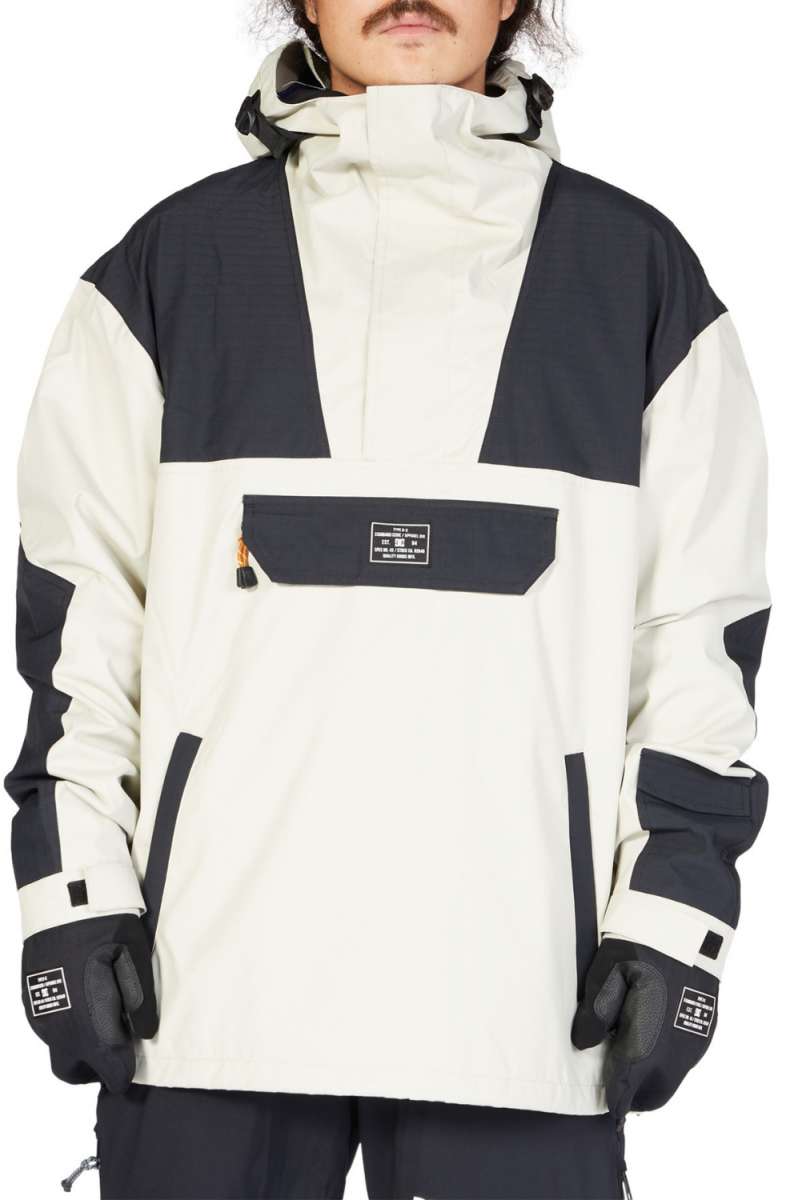 DC 43 Anorak Jacket 2023 - A black and white jacket with a hood, featuring a zippered chest pocket and adjustable cuffs.