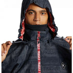 DC AW Vista Shell Jacket 2024 - A black jacket with a repeating pattern of white "Fragile" labels and a red zipper pull.