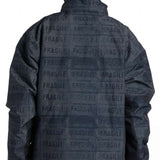 DC AW Vista Shell Jacket 2024 - A black jacket with a repeating pattern of white rectangles featuring the word "fragile" in various fonts and orientations.