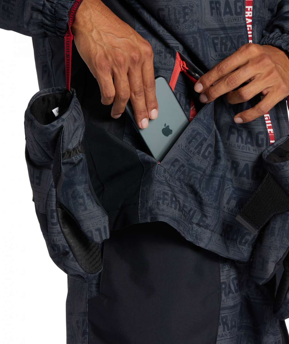 DC AW Vista Shell Jacket 2024 - A navy blue jacket with a subtle white pattern and red accents on the zipper and trim.