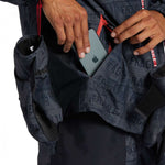 DC AW Vista Shell Jacket 2024 - A navy blue jacket with a subtle white pattern and red accents on the zipper and trim.