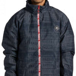 DC AW Vista Shell Jacket - A black jacket with a repeating pattern of "DC" and "AW" logos in white, featuring a zipper down the front.