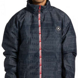 DC AW Vista Shell Jacket - A black jacket with a repeating pattern of "DC" and "AW" logos in white, featuring a zipper down the front.