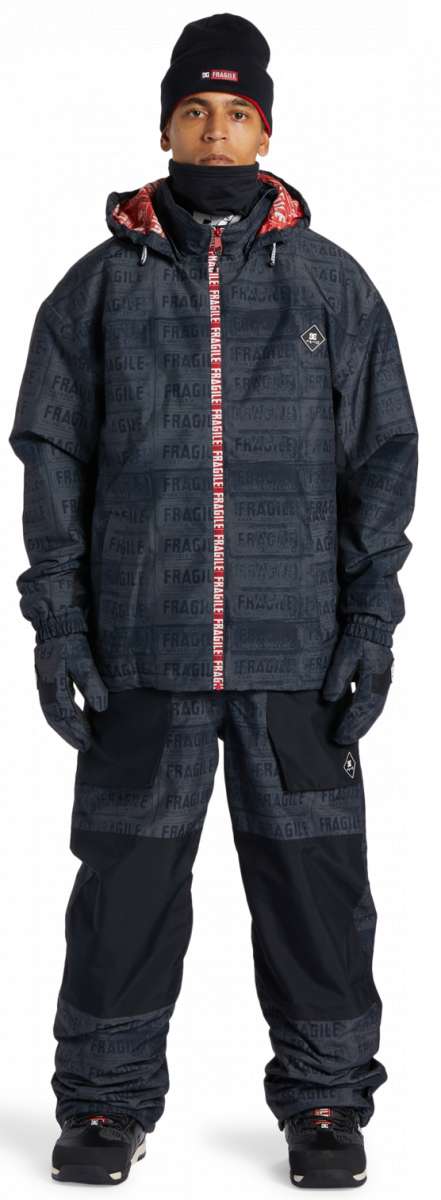 DC AW Vista Shell Jacket 2024 - A black jacket with a red zipper and white logo on the left chest.