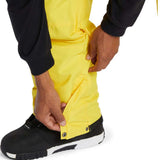 DC Banshee Insulated Pant 2024 - Yellow snow pants with black trim and silver snap buttons on the side of one leg.
