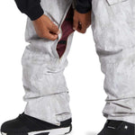 DC Banshee Insulated Pant 2024 - A pair of gray snowboard pants with a subtle marbled pattern, featuring black accents and a zippered pocket on the right thigh.