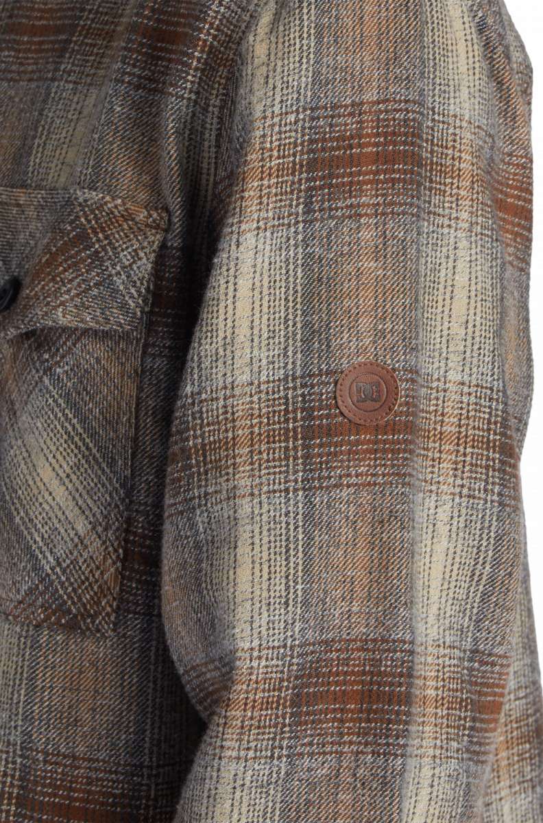 DC Canyon Full Zip Flannel 2024 - A plaid flannel jacket with a full zip and two chest pockets, featuring a brown, white, and black color scheme.