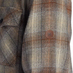 DC Canyon Full Zip Flannel 2024 - A plaid flannel jacket with a full zip and two chest pockets, featuring a brown, white, and black color scheme.