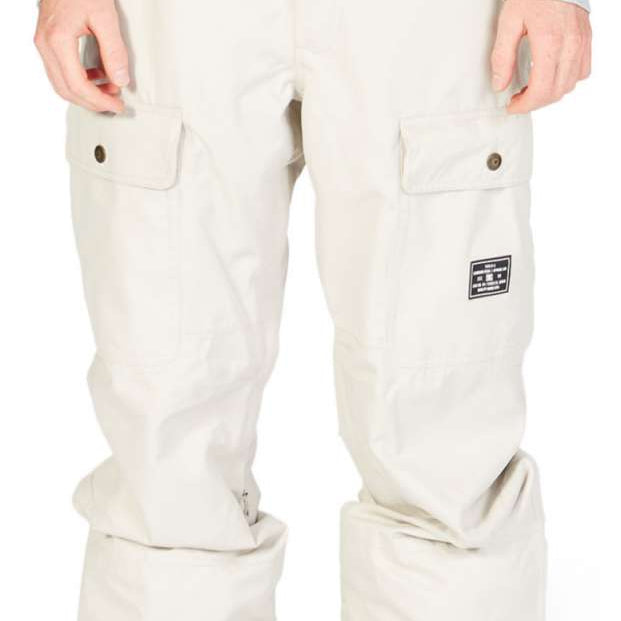 DC Code Shell Pant 2023 - Beige snow pants with zippered pockets, adjustable cuffs and belt loops.