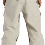 DC Code Shell Pant 2024 - Beige snow pants with zippered pockets and adjustable cuffs.