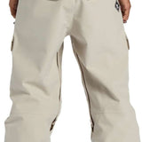DC Code Shell Pant 2024 - Beige snow pants with zippered pockets and adjustable cuffs.