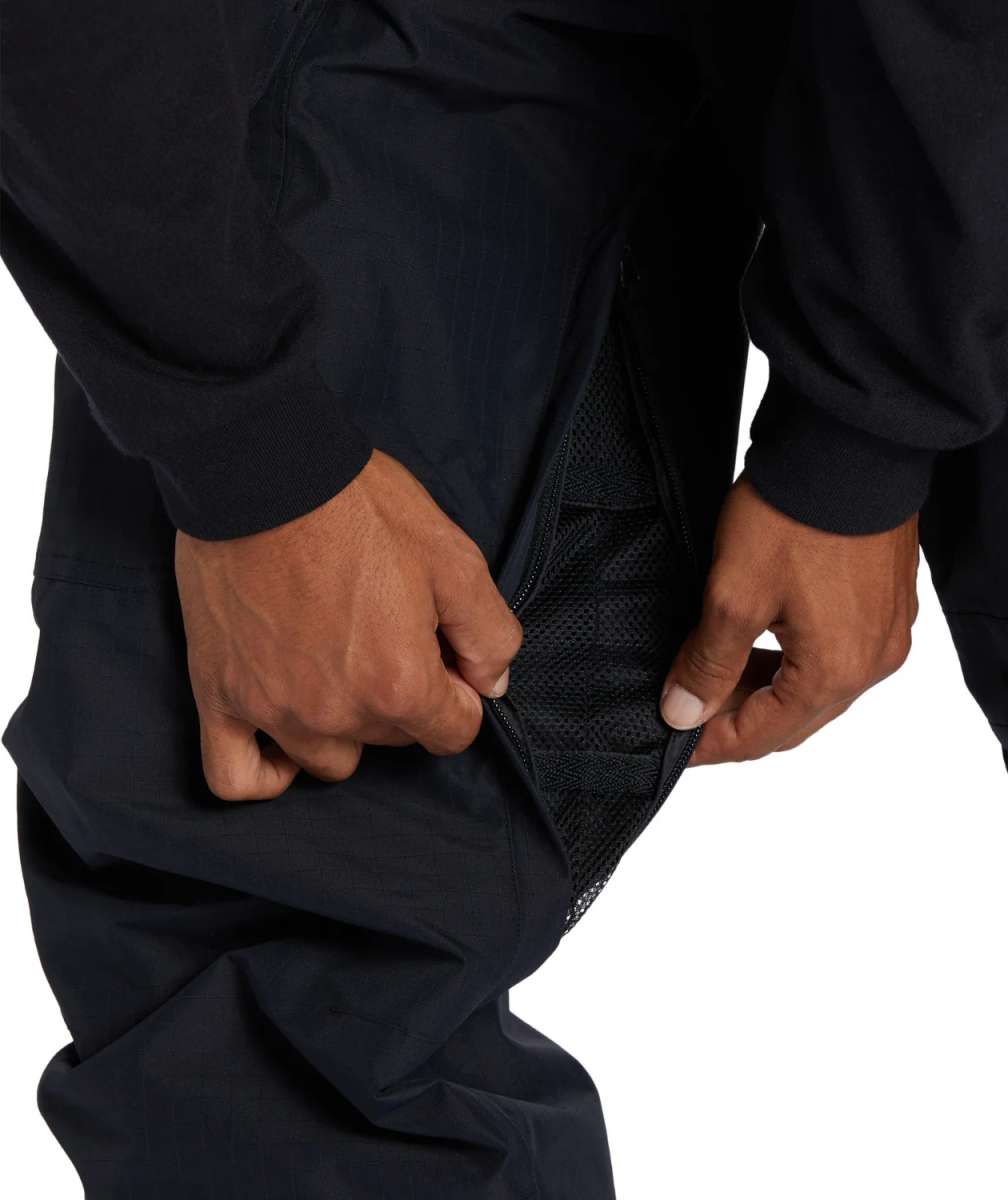 DC Code Shell Pant 2024 - Black snow pants with a zippered leg pocket on the right side.