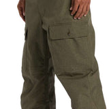 DC Code Shell Pant 2024 - Olive green pants with two front pockets and a zippered pocket on the thigh.