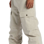 DC Code Shell Pant 2024 - Beige pants with a subtle sheen, featuring two front pockets and a zippered fly.