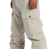 DC Code Shell Pant 2024 - Beige pants with a subtle sheen, featuring two front pockets and a zippered fly.