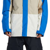 DC Defy Insulated Jacket 2024 - A blue, tan, and white jacket with a hood and zippered pockets.