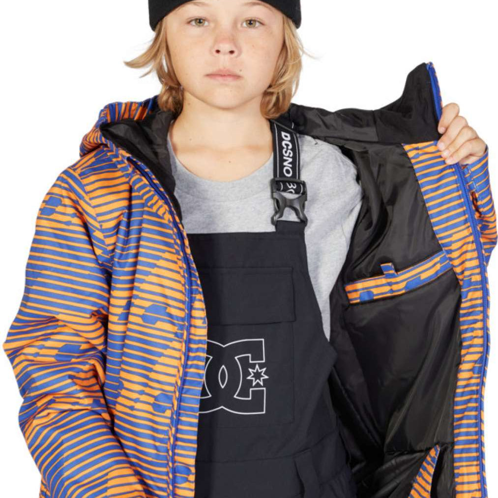 DC Juniors Propaganda Insulated Jacket 2023 - A blue and orange striped jacket with a black hood, worn by a model on a solid gray background.