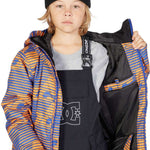 DC Juniors Propaganda Insulated Jacket 2023 - A blue and orange striped jacket with a black hood, worn by a model on a solid gray background.