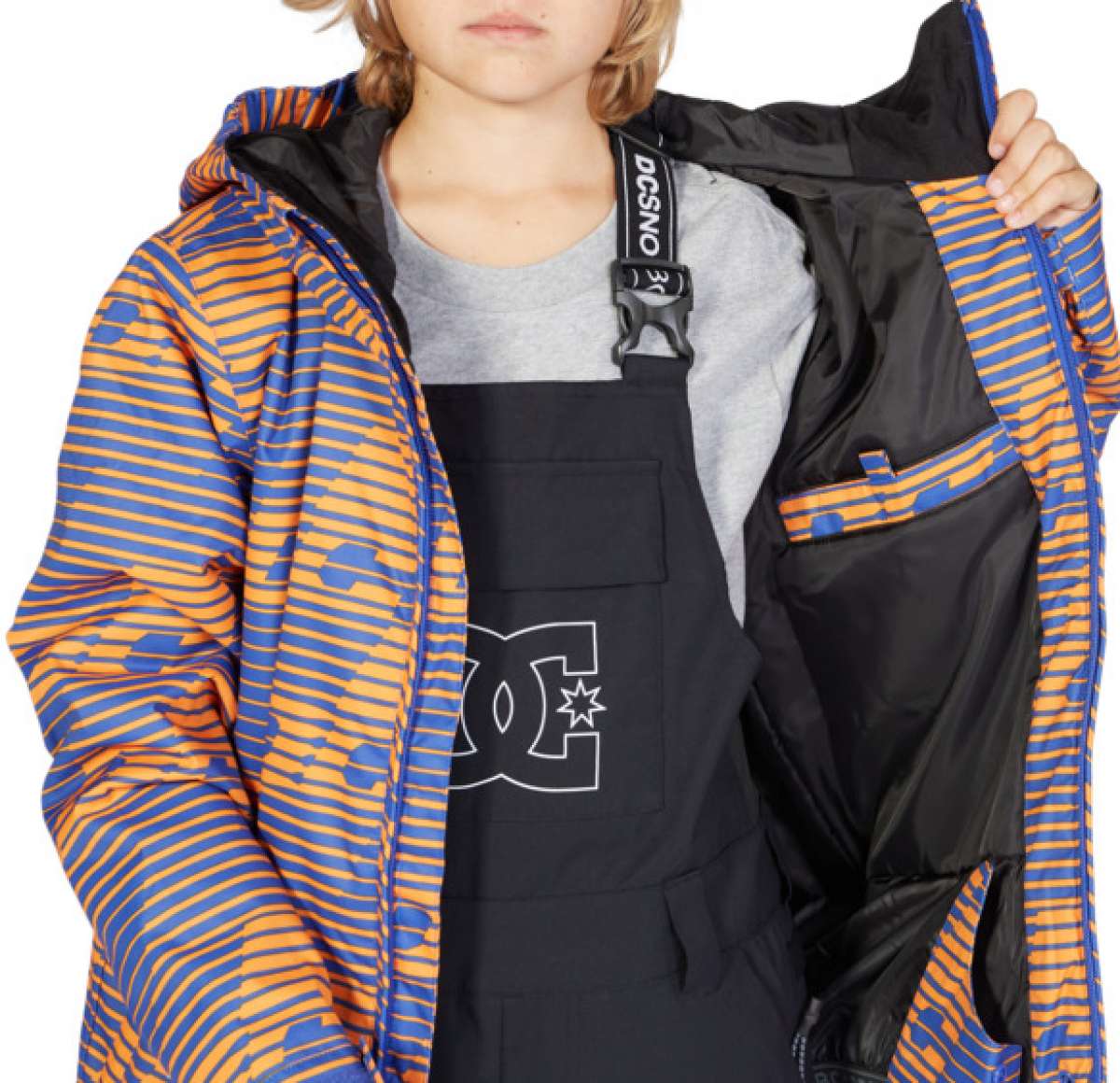 DC Juniors Propaganda Insulated Jacket 2023 - A blue and orange striped jacket with a hood, worn by a model over a gray shirt.