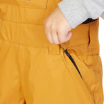 DC Juniors Roadblock Bib 2023 - A pair of yellow snow pants with a black zipper on the side pocket.