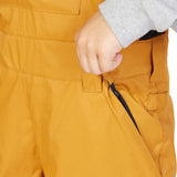 DC Juniors Roadblock Bib 2023 - A pair of yellow snow pants with a black zipper on the side pocket.