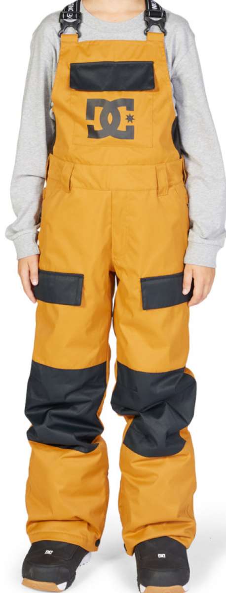 DC Juniors Roadblock Bib 2023 - A pair of bib snow pants with a black and grey patterned design on the front, featuring a large DC logo in white letters.