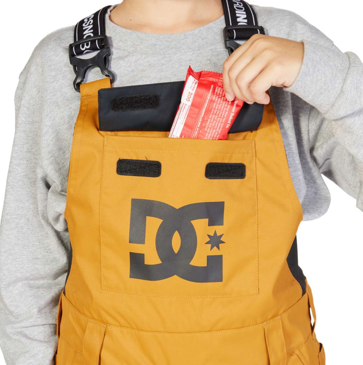 DC Juniors Roadblock Bib 2023 - A pair of bib snow pants with a black and white geometric pattern on the left leg.