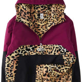 DC Women's Nexus Reversible Anorak Jacket 2024 - A black jacket with a leopard print lining and a hood, featuring a zipper closure.