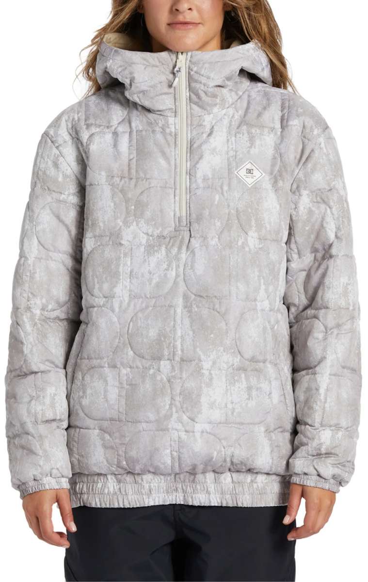 DC Women's Nexus Reversible Anorak Jacket 2024 - A light gray jacket with a subtle pattern of darker gray circles, featuring a hood and a zipper down the front.