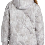 DC Women's Nexus Reversible Anorak Jacket 2024 - A light gray jacket with a subtle pattern of darker gray lines and circles, featuring a hood and zippered pockets on both sides.