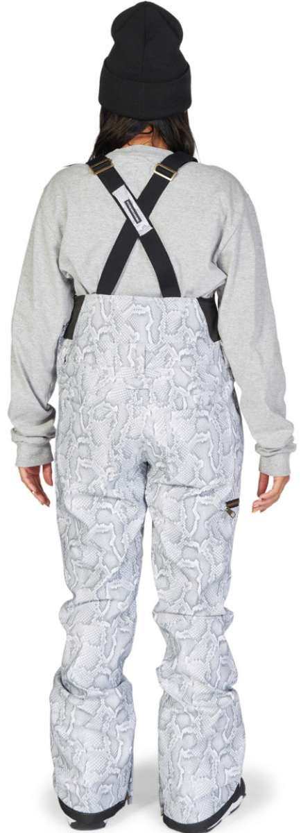 DC Women's Collective Shell Bib 2023 - White snow pants with a subtle gray pattern of abstract shapes and lines, featuring black suspenders and gold buckles.