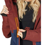DC Women's Cruiser Insulated Jacket 2023 - A burgundy jacket with a black zipper and two zippered pockets on either side.