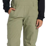 DC Women's Crusade Shell Bib Pant 2024 - A pair of khaki green snow pants with a zippered pocket on the thigh and adjustable straps at the waist.