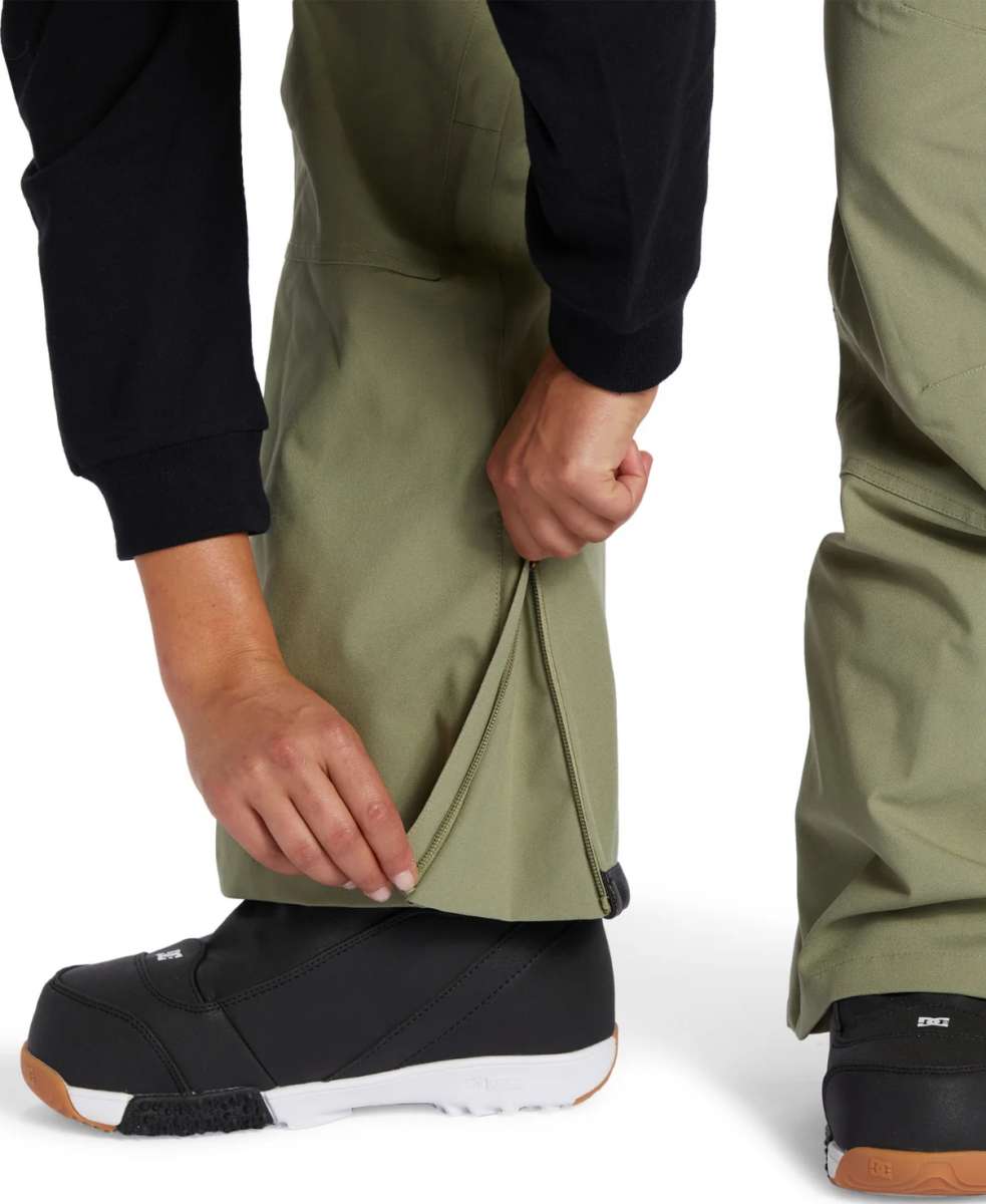 DC Women's Crusade Shell Bib Pant 2024 - A pair of olive green snow pants with a zippered pocket on the thigh and adjustable velcro straps at the waist.