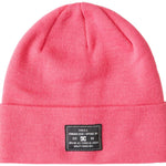 DC Women's Label Beanie 2023 - A pink beanie with a black label featuring white lettering on the front.