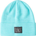 DC Women's Label Beanie 2023 - A light blue beanie with a black label featuring white lettering on the front.
