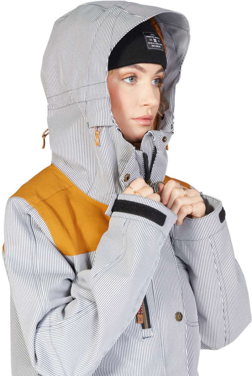 DC Women's Liberate Insulated Jacket 2023 - A black and white striped jacket with a yellow panel on the left shoulder.