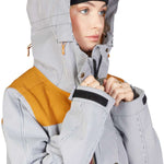 DC Women's Liberate Insulated Jacket 2023 - A black and white striped jacket with a yellow panel on the left shoulder.