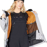 DC Women's Liberate Insulated Jacket 2023 - A black jacket with a white stripe on the left sleeve and a zippered pocket on the right side.