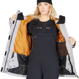 DC Women's Liberate Insulated Jacket 2023 - A black jacket with a white stripe on the left sleeve and a zippered pocket on the right side.