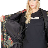 DC Women's Liberate Insulated Jacket 2023 - A black jacket with a floral pattern lining and a white logo on the chest.