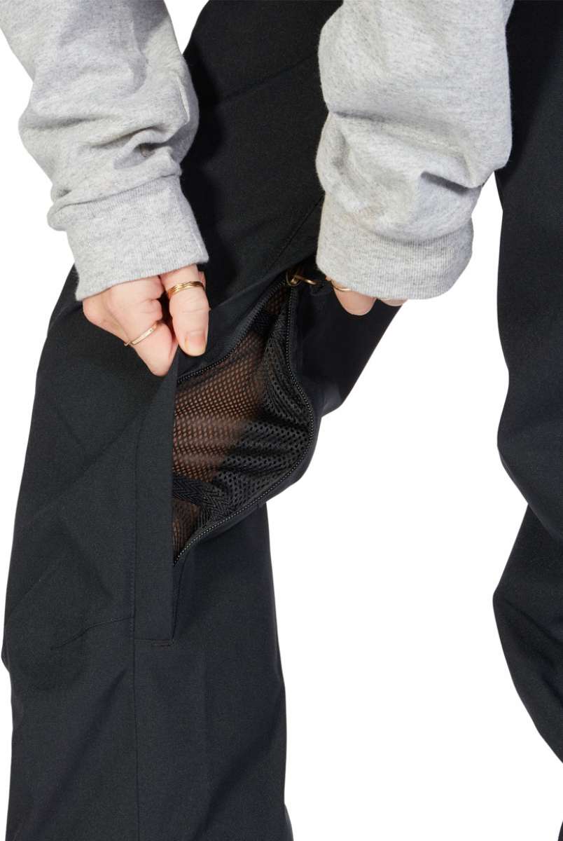DC Women's Viva Shell Pant 2023 - Black pants with a zippered pocket on the side and a mesh lining visible through the fabric.