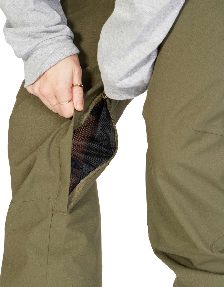 DC Women's Viva Shell Pant 2023 - Olive green pants with a zippered pocket on the thigh and a mesh lining visible through the zipper opening.
