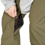 DC Women's Viva Shell Pant 2023 - Olive green pants with a zippered pocket on the thigh and a mesh lining visible through the zipper opening.