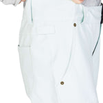 DC Women's Viva Shell Pant 2023 - White pants with a zippered pocket on the side and a small logo patch near the bottom hem.