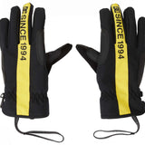 DC Salute Gloves 2024 - Black gloves with yellow accents on the wrist strap and fingers.
