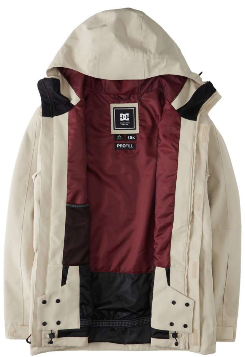 DC Servo Insulated Jacket 2024 - A cream-colored jacket with a black zipper and two zippered pockets on either side.