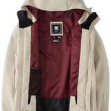 DC Servo Insulated Jacket 2024 - A cream-colored jacket with a black zipper and two zippered pockets on either side.