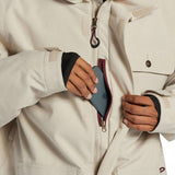 DC Servo Insulated Jacket - A cream-colored jacket with a black zipper and two chest pockets, one of which has a small black button on it.